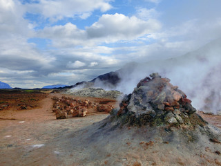 Geothermal hot springs natural area with steaming sulfur pools and vibrant color