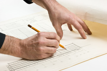 hand draws a pencil on drawing