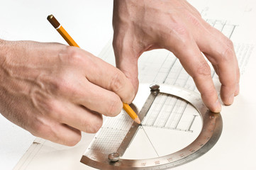 hand draws a pencil on drawing
