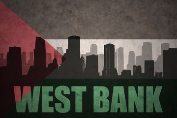 abstract silhouette of the city with text West Bank at the vintage palestinian flag background