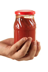 jar tomato paste in hand