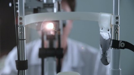 A modern medical device for eye checking. Unrecognizable doctor working with patient eye testing. HD.