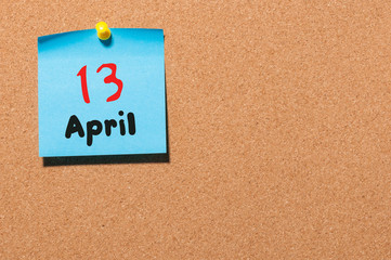 April 13th. Day 13 of month, calendar on cork notice board, business background. Spring time, empty space for text