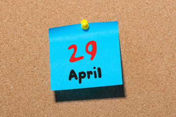 April 29th. Day 29 of month, calendar on cork notice board, business background. Spring time, empty space for text