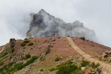 Clouds flowing over mountain at Madeira Island, Portugal, Mountain peak Pico do Arieiro.