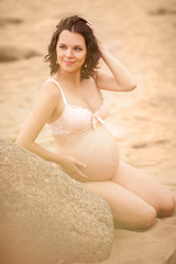 Pregnant woman resting on the beach
