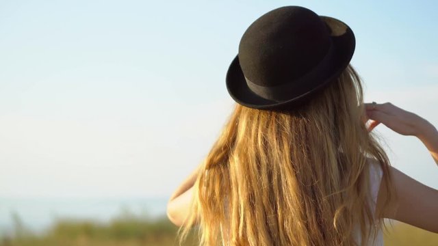 Young beautiful woman model in hat and sunglasses posing and smiling outdoor 4K