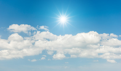 Naklejka na ściany i meble Blue sky with clouds and sun reflection