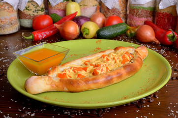 flan with pumpkin and cheese in a round green plate on a wooden table with pumpkin sauce