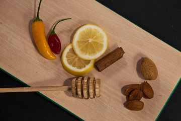 Lemon, nuts, spices and chili on board