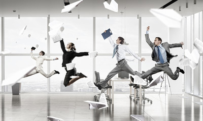 Dancing businesspeople in office room . Mixed media