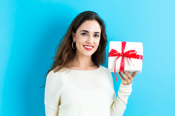 Young woman holding a Christmas gift