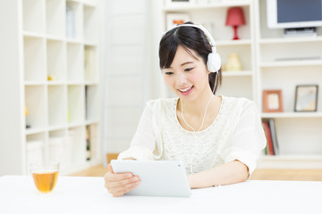 attractive asian woman using tablet computer © taka