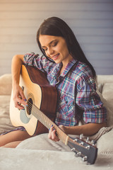 Attractive girl playing guitar