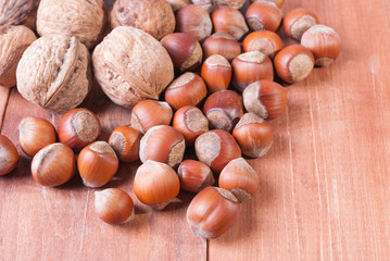 Walnuts and hazelnuts on wooden background