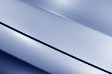 Surface of blue sport sedan car metal hood, part of vehicle bodywork, steel gradient line pattern, selective focus  - 123403306