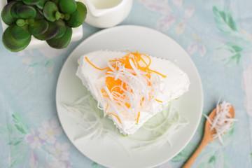 Green pandan cake and fresh cream with coconut on top