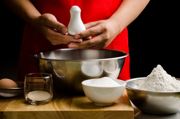 Preparation bread cooking,holding the bottle of salt