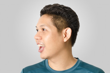 Fototapeta premium Portrait of asian man feeling wow isolated on gray background
