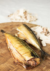 Wood smoked fish. Homemade smoked mackerel. Smoker. Hickory wood chips.