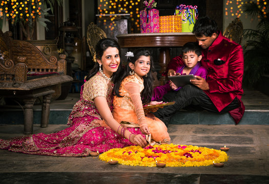 Indian young Family arranging diyas on rangoli on diwali festival night,  people and diwali Stock Photo | Adobe Stock