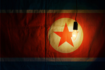 North Korean flag lit by a lamp