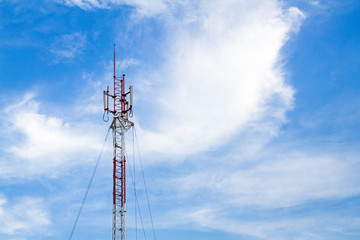 Obraz premium Telecommunication tower on blue sky and clouds background