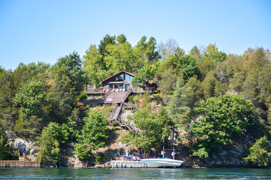 Kingston, Canada - September 3, 2016: One Island with the white house in Thousand Islands Region in summer in Kingston, Ontario, Canada