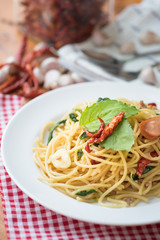 Spicy spaghetti with sausage, basil and chilli