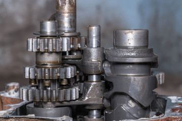 Gear metal wheels close-up. Industrial mechanism - inside of motorcycle engine 
