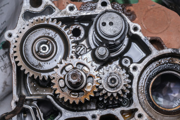 Gear metal wheels close-up. Industrial mechanism - inside of motorcycle engine 
