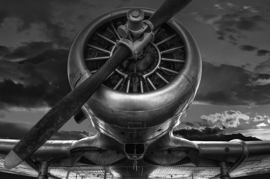 The warplane from the past "T-6G HARVARD" in black and white photo, cloudy sky background