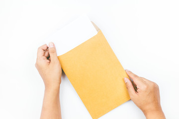 Hands holding brown leather envelope with a empty paper on white