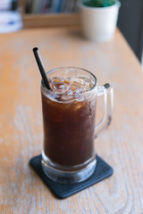 Iced Americano black coffee on a wooden table. shallow depth of