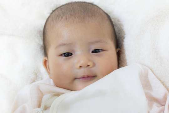 Close - Up Two month old new born asian cute baby smile rests ha