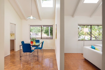 Side View Into Simple Modern Living and Dining Room with Sky Lig