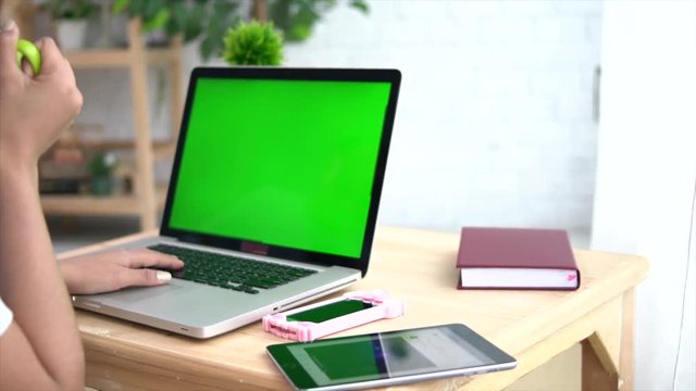 Asian Woman Using A Green Screen Notebook Computer