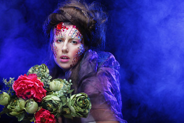 woman in creative image  with big flowers.