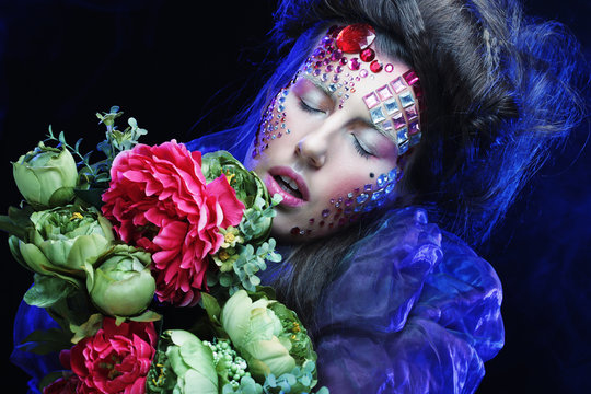 woman in creative image  with big flowers.