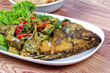 Close up of green tilapia fish curry in coconut milk is popular Thai cuisine .Selective focus.