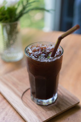 Iced Americano black coffee on a wooden table. shallow depth of