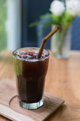 Iced Americano black coffee on a wooden table. shallow depth of