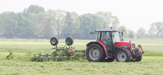 Leeuwarden, the Netherlands - May 26, 2016: Farmer uses tractor