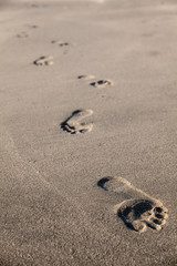 Footprints on the beach of Half Moon Bay, California