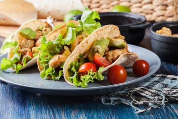 Authentic mexican tacos with chicken and salsa with avocado, tomatoes and chillies