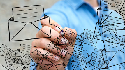 Businessman drawing manuscript contact icon with a pen