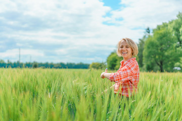 Fototapeta premium Portrait of beautiful girl in green field
