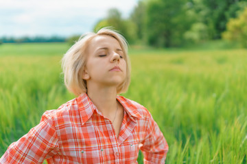 Portrait of beautiful girl in green field