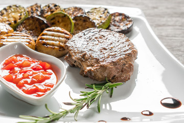 Appetizing stake on white plate. Grilled meat