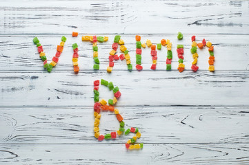 From pieces of colored candied fruits laid out the word vitamin B2.